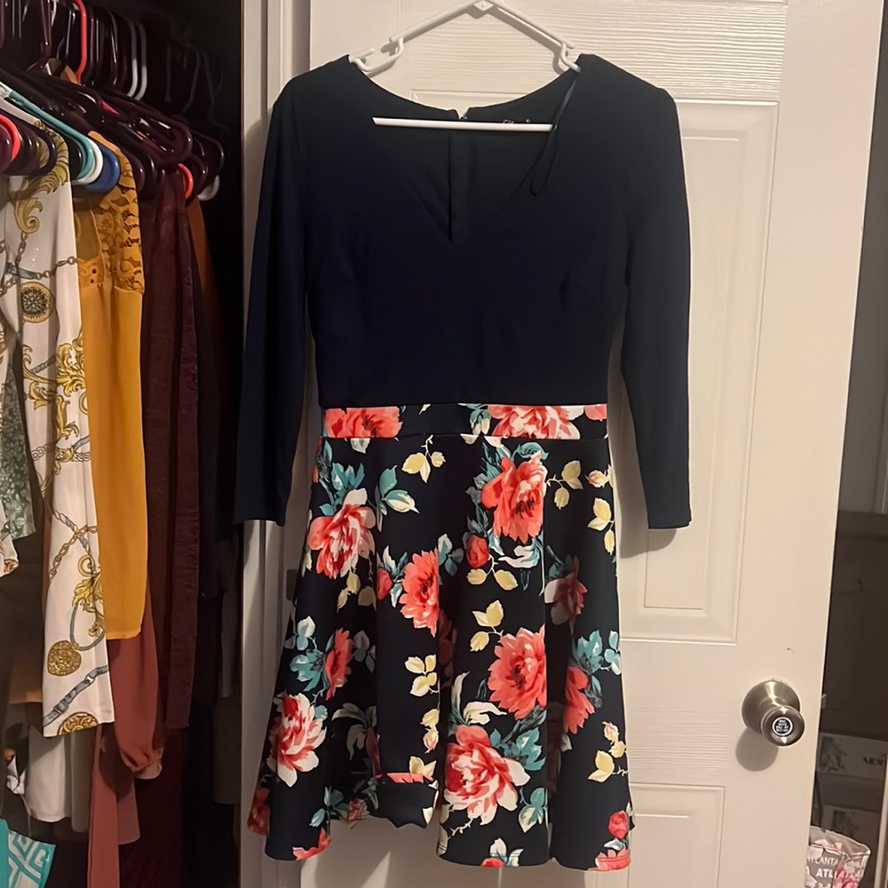 A beautiful spring dress with pink roses on the bottom.